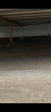 Zoomed in picture of under the bed. Dust and dirt