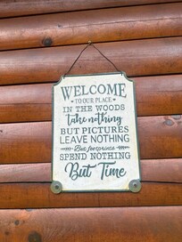 Sign by the cute plants, flowers and a pumpkin vine! So cute!