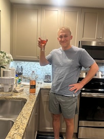 The groom enjoying some of momâs homemade wine at the condo. Mom and son time.đ©·