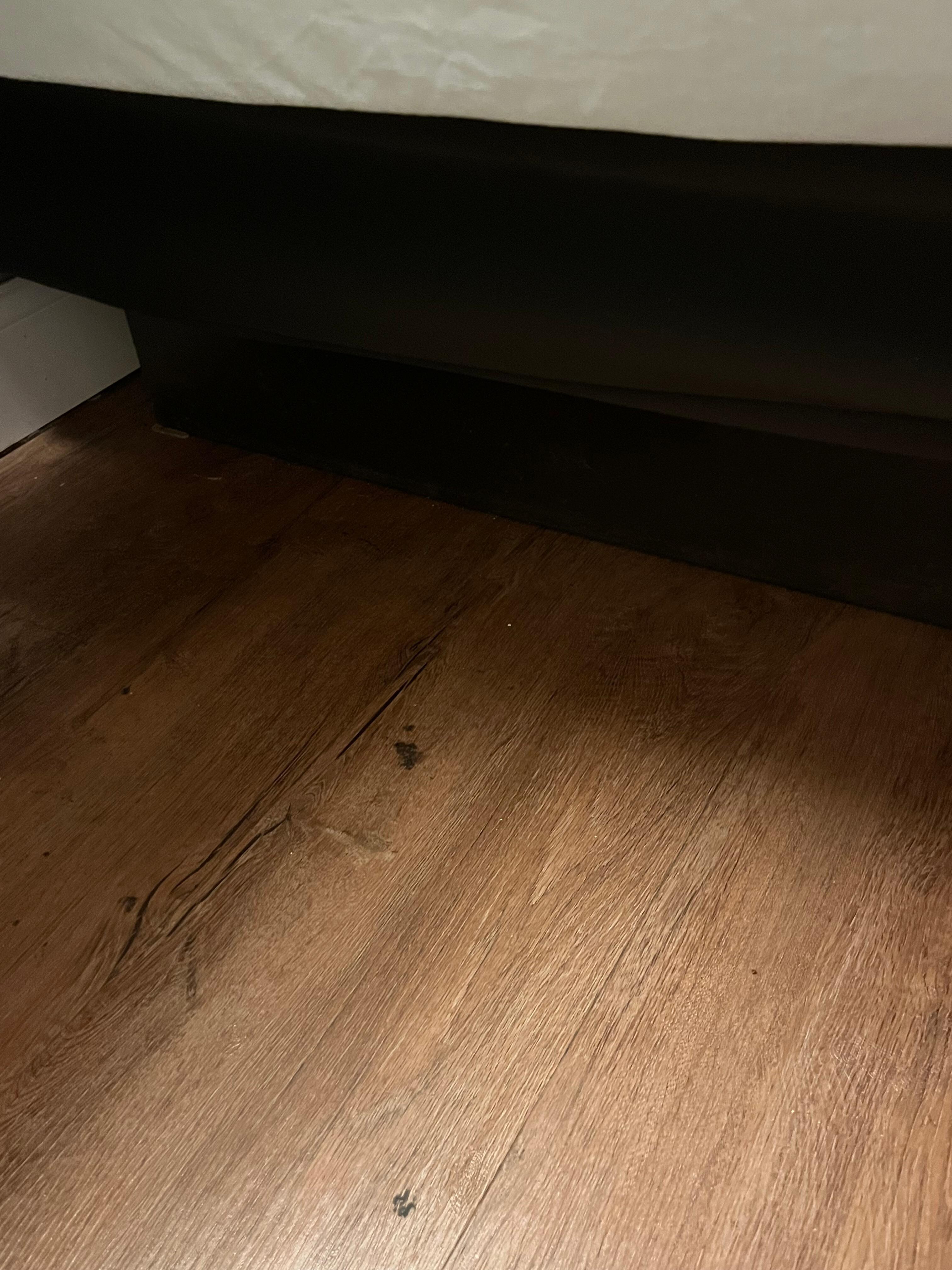 Black debris stuck to floor.