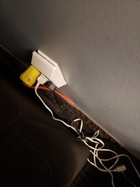 Extension cords plugged into powerbars plugged into another power block which is coming out of the wall. Notice the heavy duty outdoor cord plugged into all of this as well.