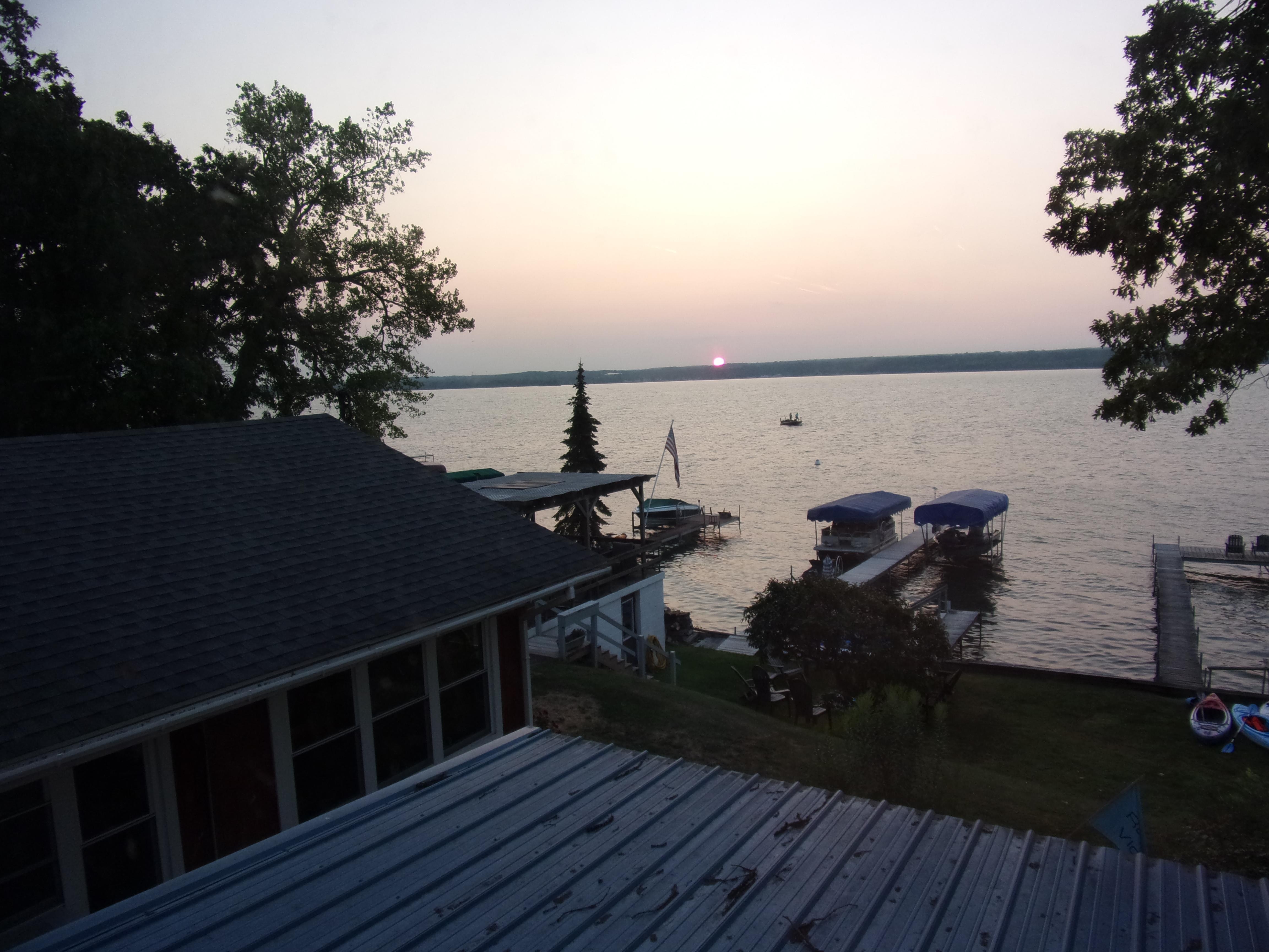 The sun pops up across the Lake from the deck, warm and claer day.