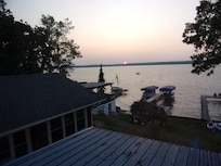 The sun pops up across the Lake from the deck, warm and claer day.
