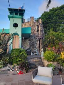 View from pool deck of house and hot tub tower