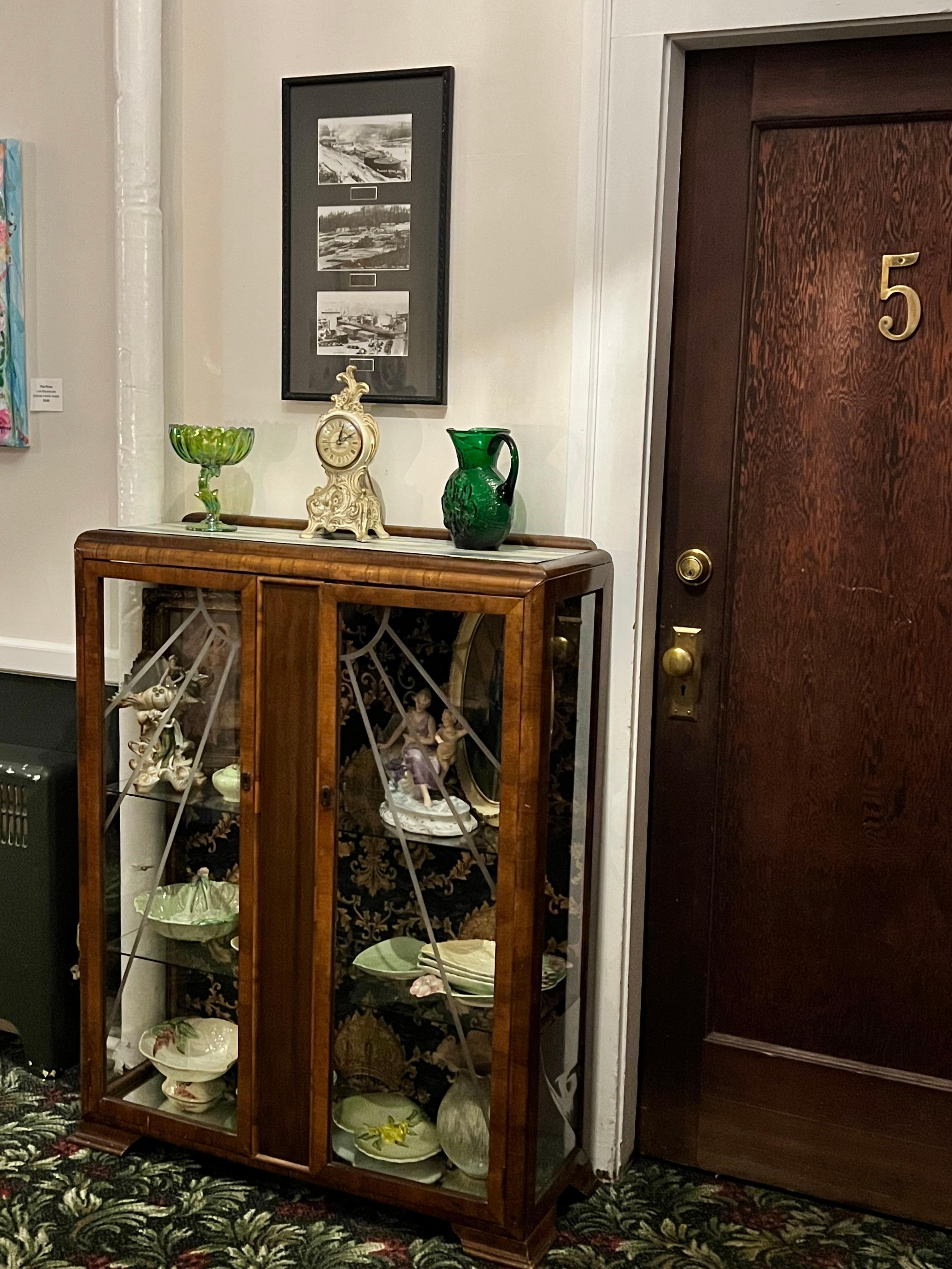 The cabinet in the hall the owner was wallpapering. 