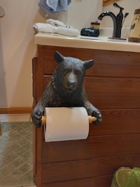 Adorable bear toilet paper holder in the hall bath