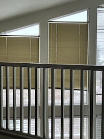 Metal 1 inch beige blinds at the top of window