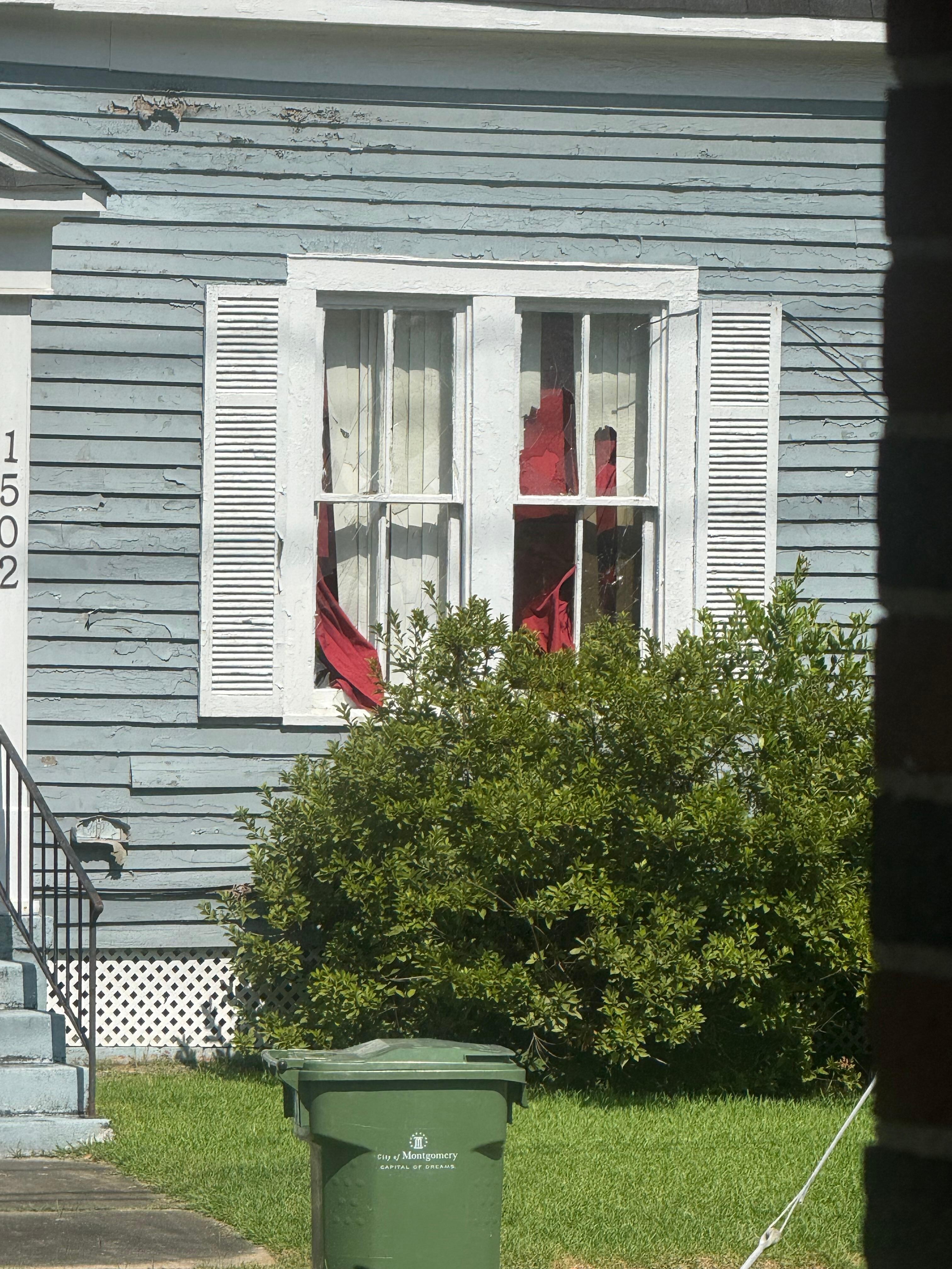Following domestic dispute, could hear them busting out windows across the street. Notice curtains hanging out of windows. 