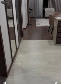 Living area with sofa , chair , dinning table and four chairs , large tv