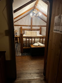 The interior, from outside the door. Out of frame to the right is the kerosene heater and a second side table.