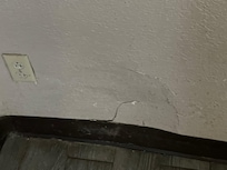 Hole in wall by bathroom
