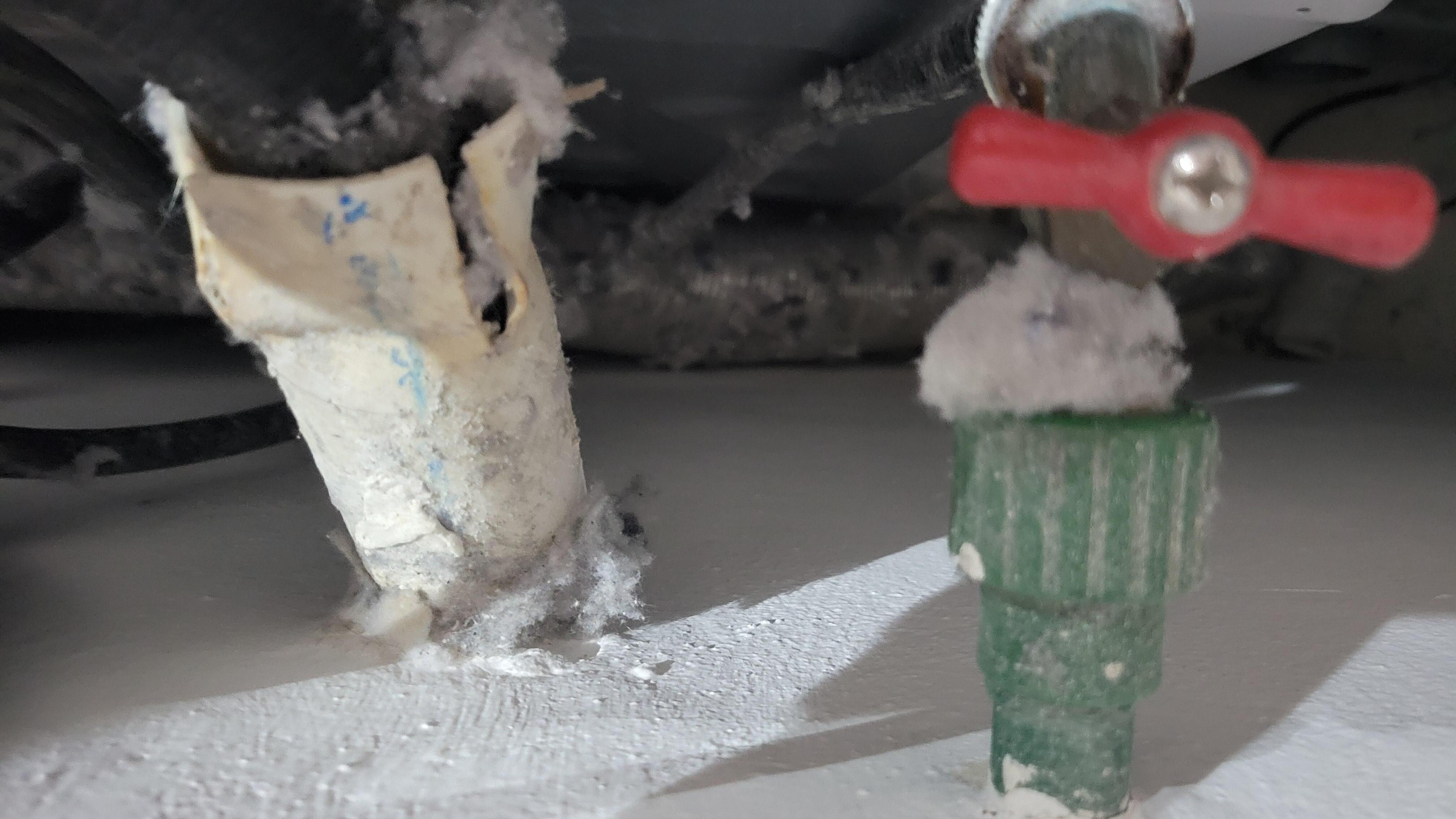 Flamable Lint and Gas Dryer material collected all around the piping and water lines.