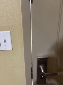 Huge gap in door to outside, compromising safety of guests and allowing bugs to enter