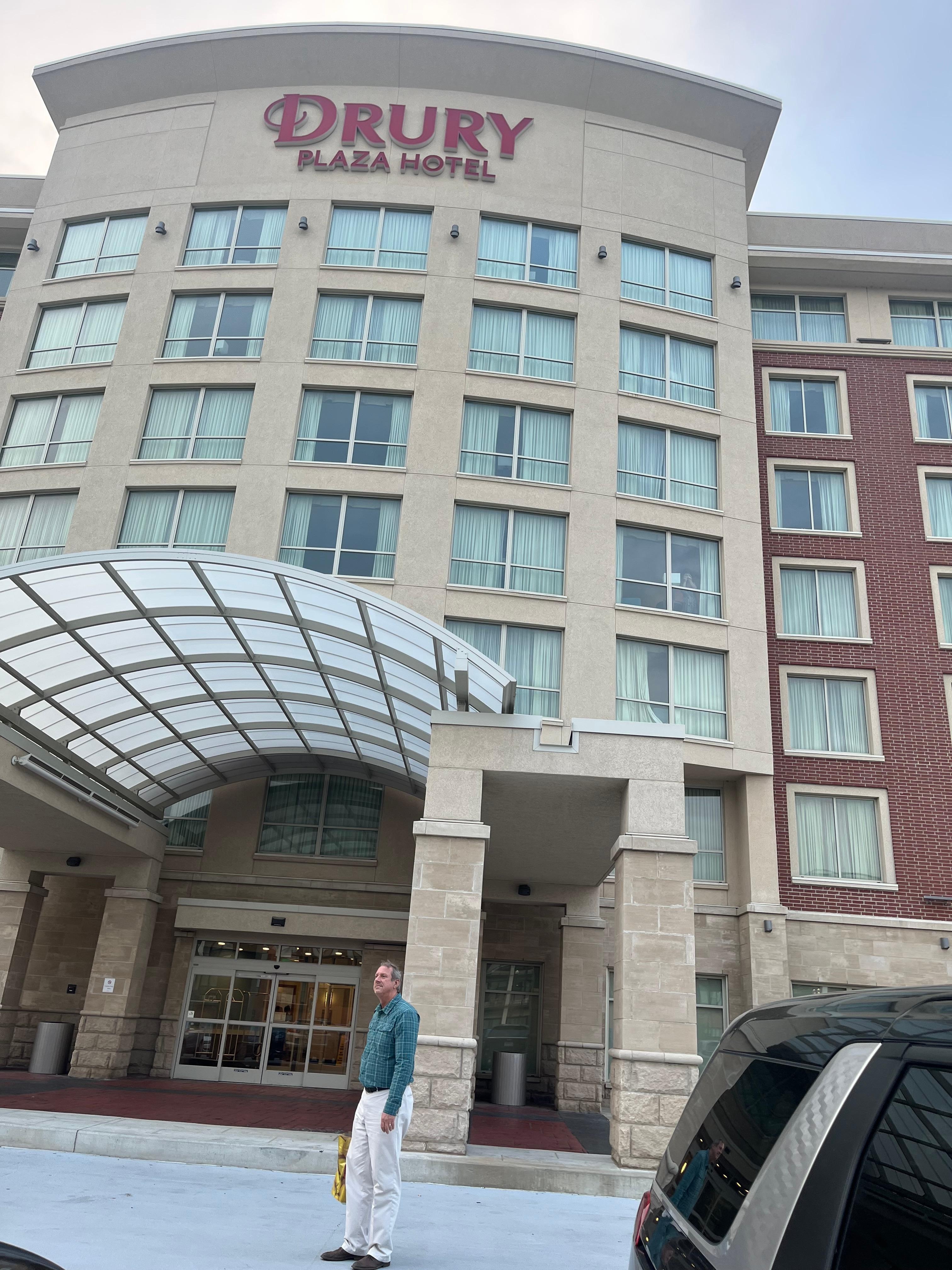 My husband enters the hotel.