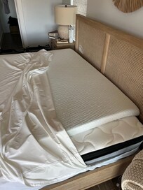 The topper was over this far on one side. And it was zipped inside a cover that had a huge stain on it.