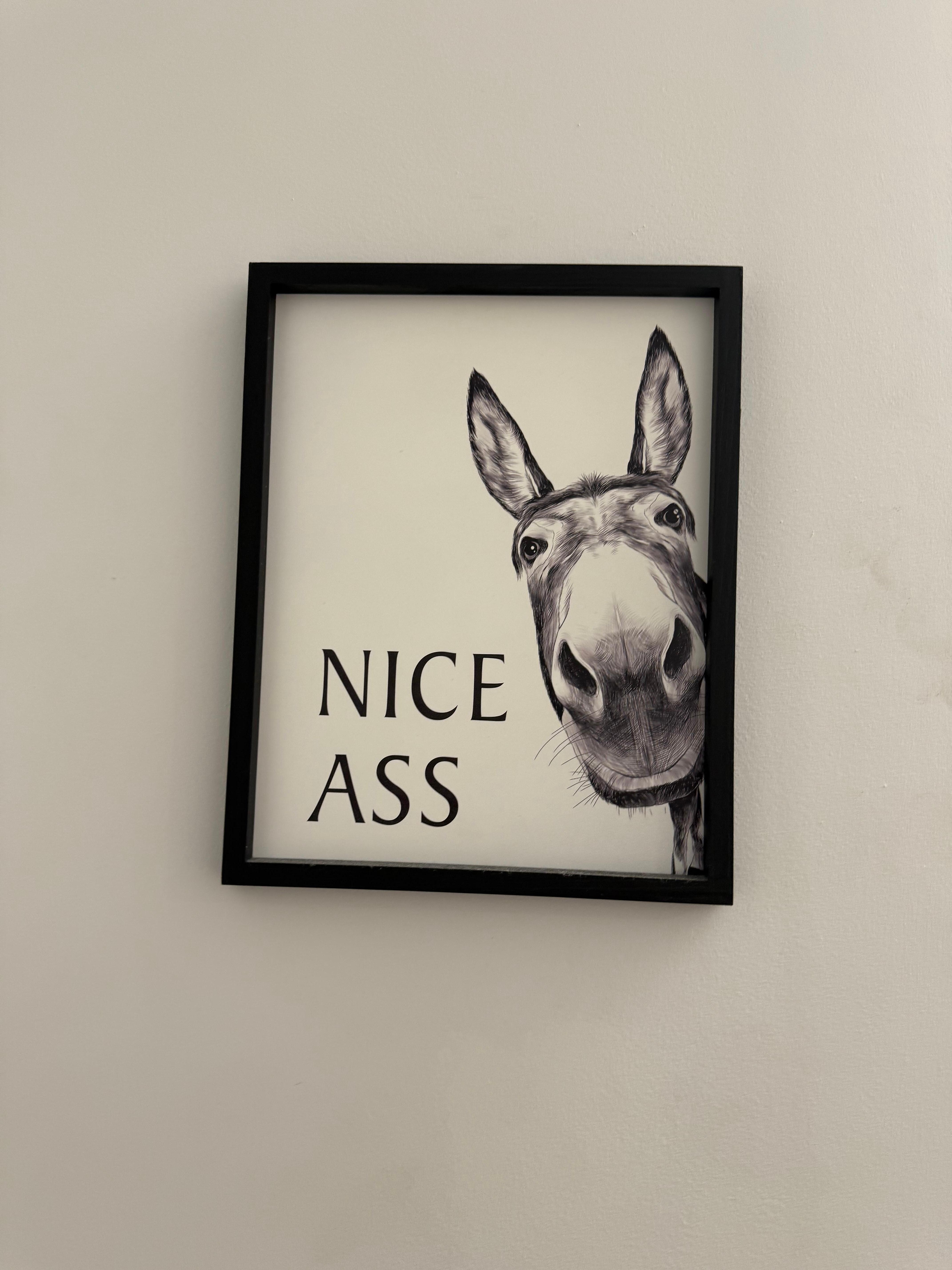 Picture over the toilet in bathroom.