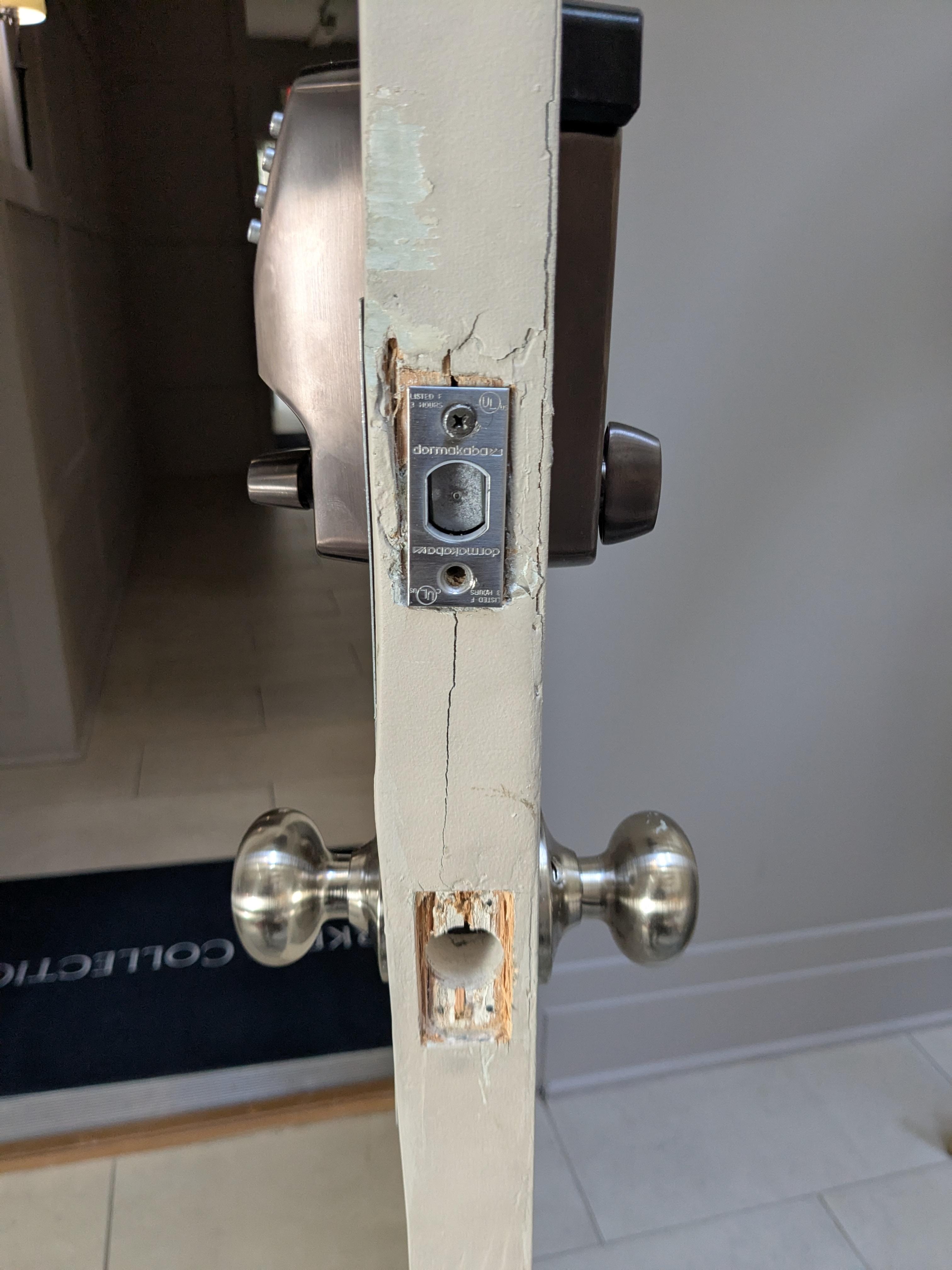 The door is cracked and a (one) sheetrock screw is being used for attachment, not correct door hardware for a secure installation