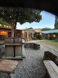 Outdoor dining with option of individual glass house shelter for some table in case of rain.