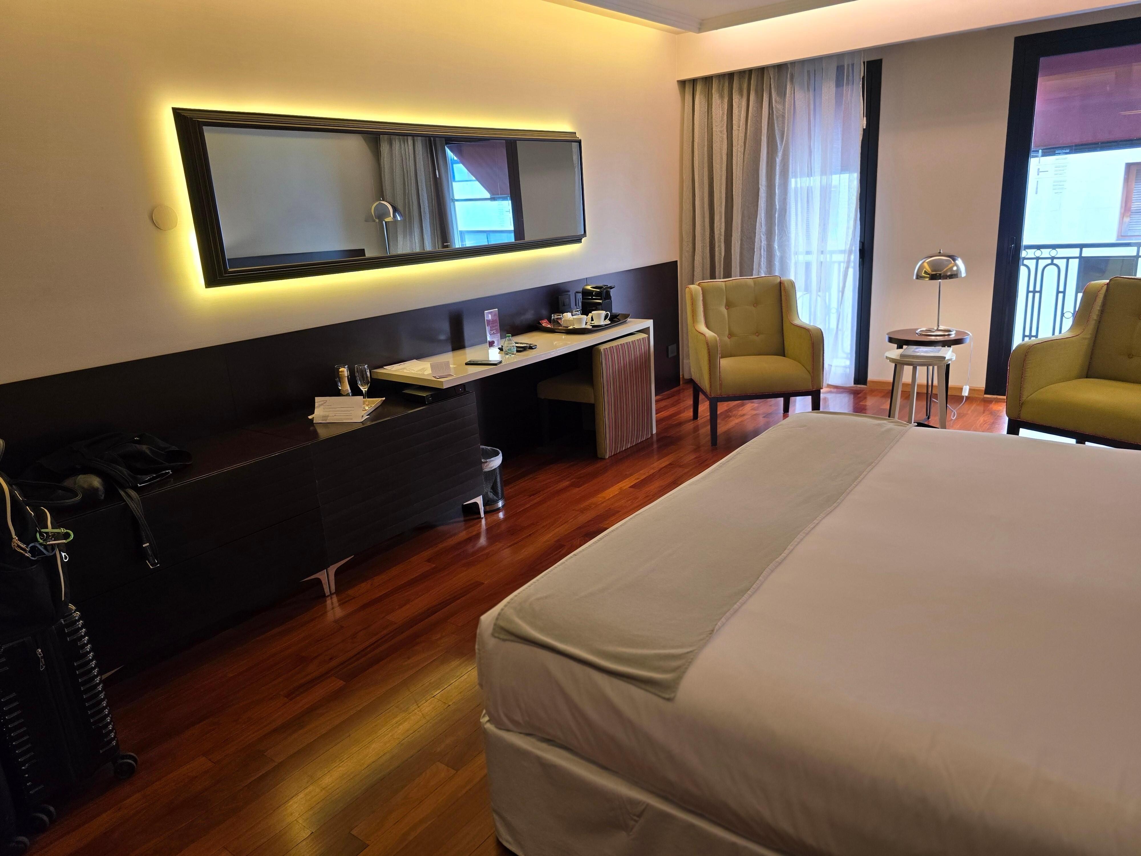 Room with king bed and balcony.