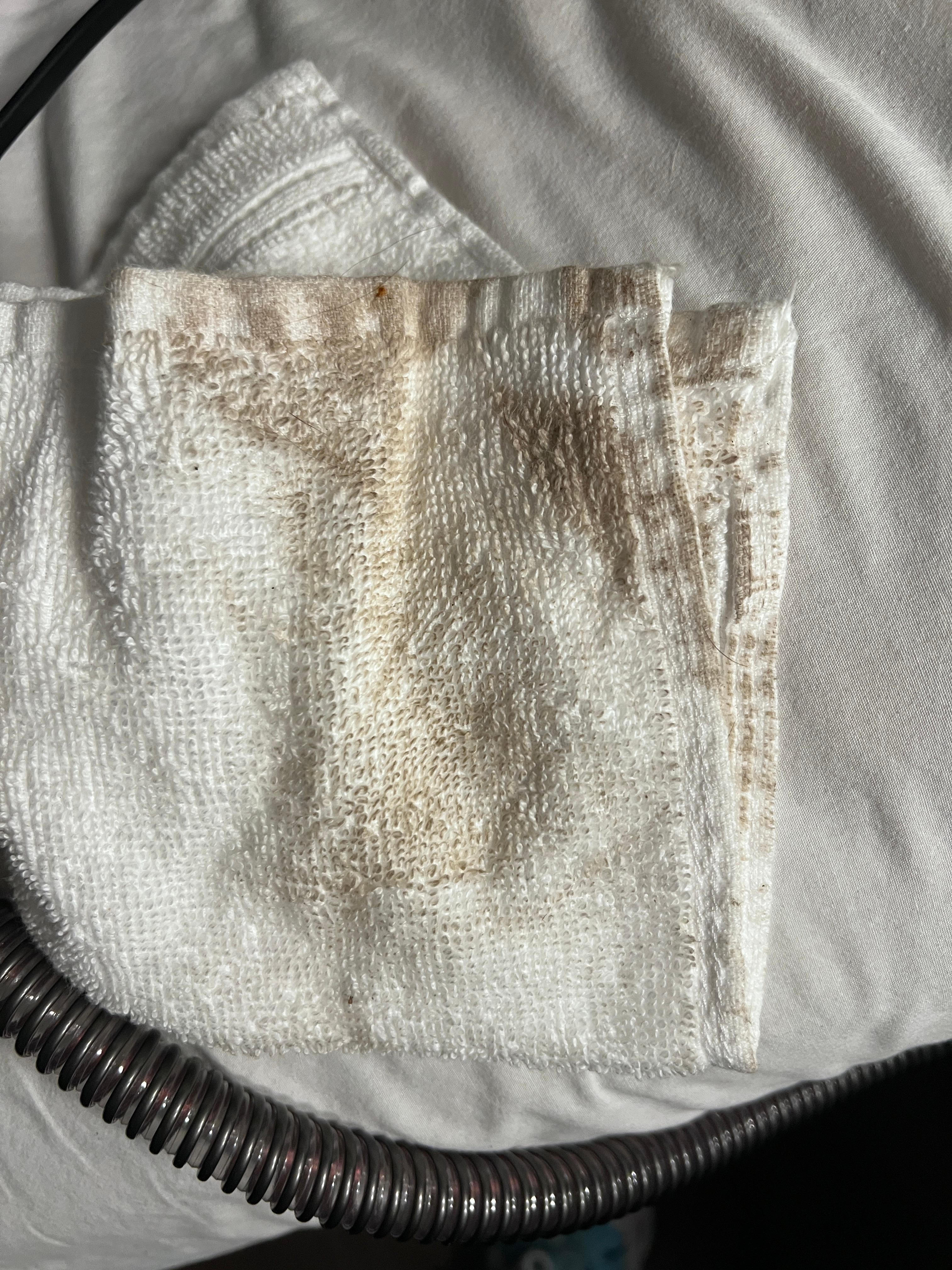The white washcloth after wiping up a small water spill