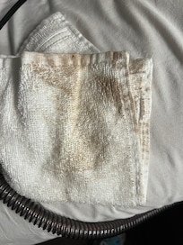 The white washcloth after wiping up a small water spill