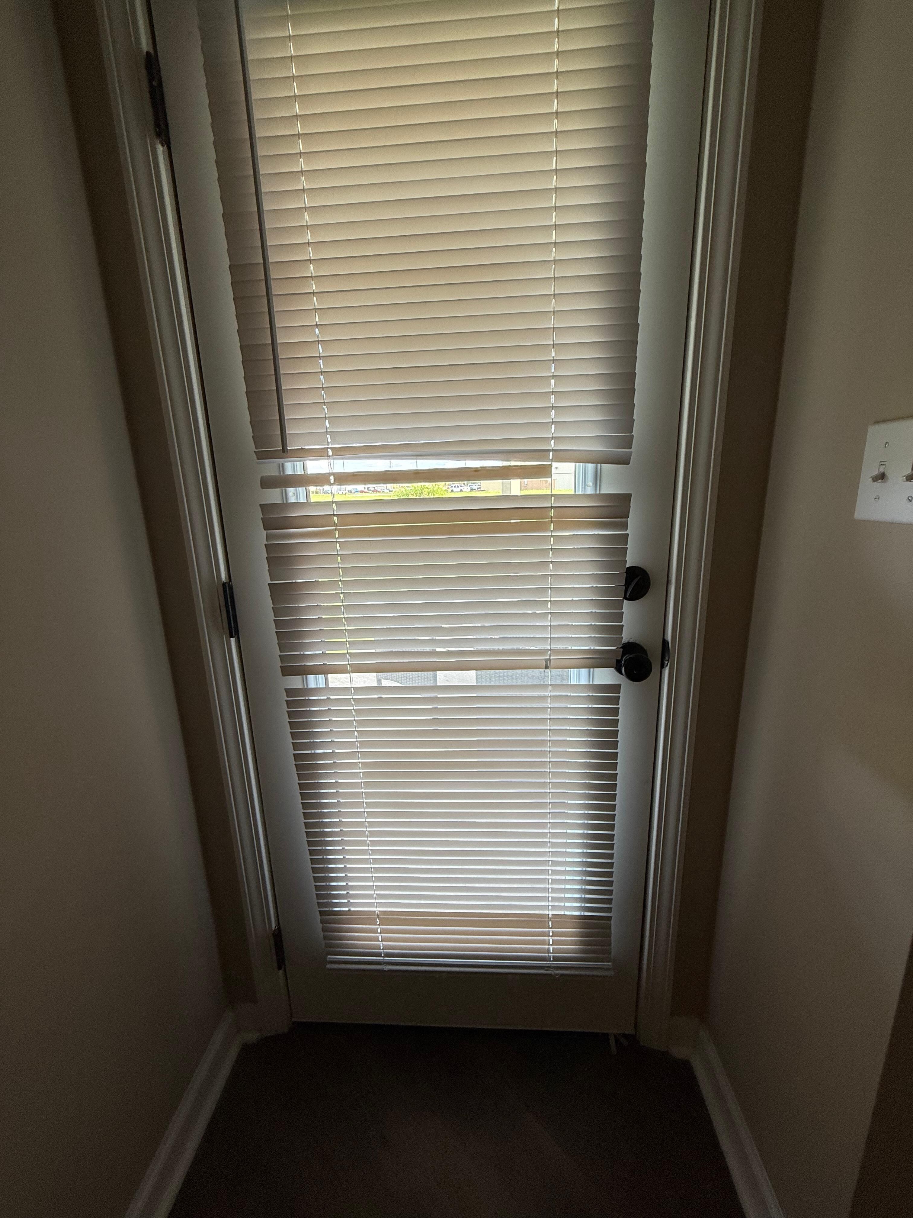 Blinds on door leading to back patio.