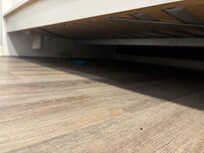 Bottles, dirty socks, and trash under the bed.