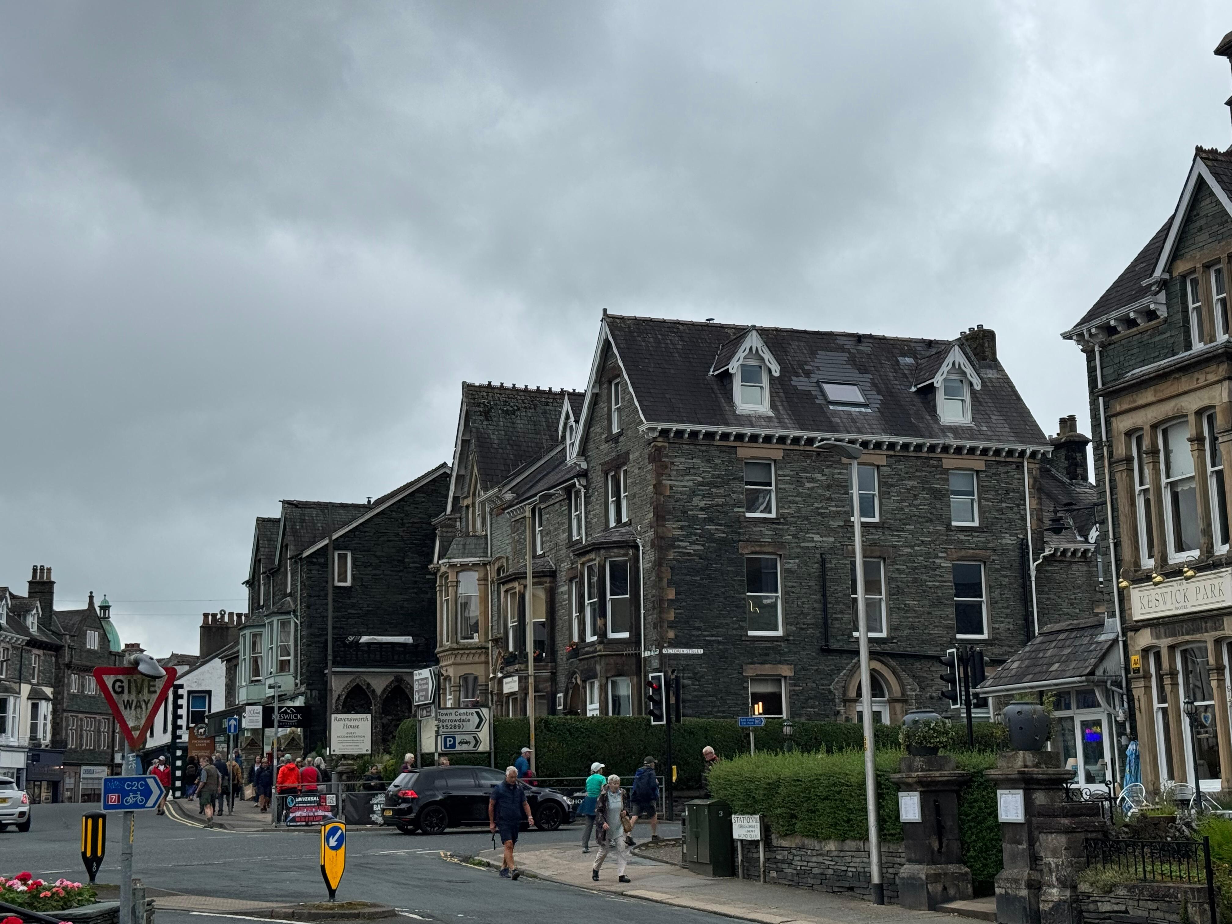 View of full property building with dormer windows and skylight on top floor