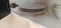 Dirt on shelve under plates.