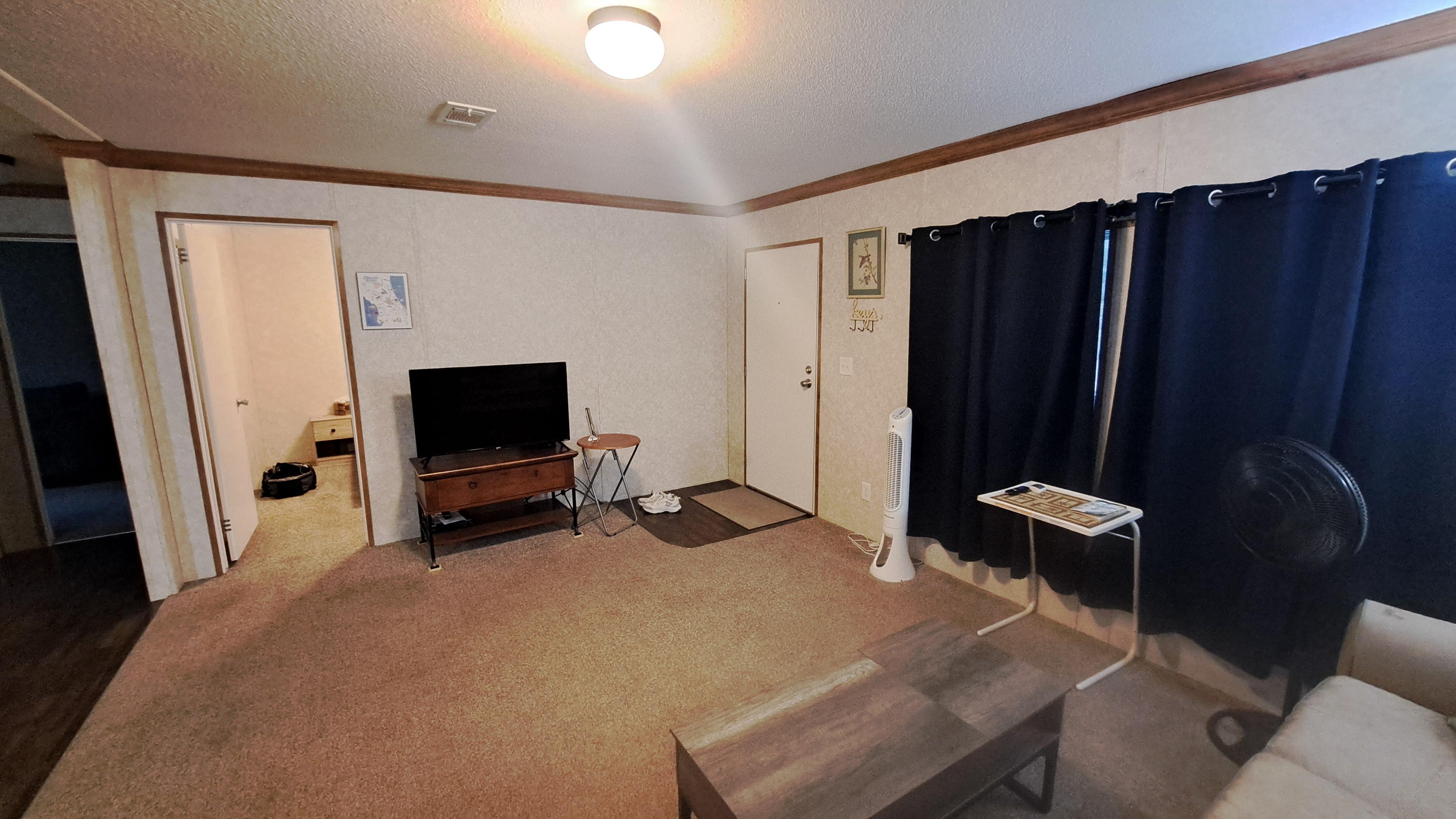 Living room, front door, and spare bedroom doorway