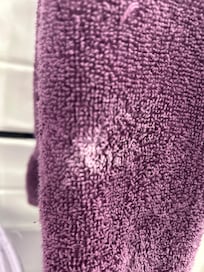 Dried toothpaste on bathroom hand towel upon checking in