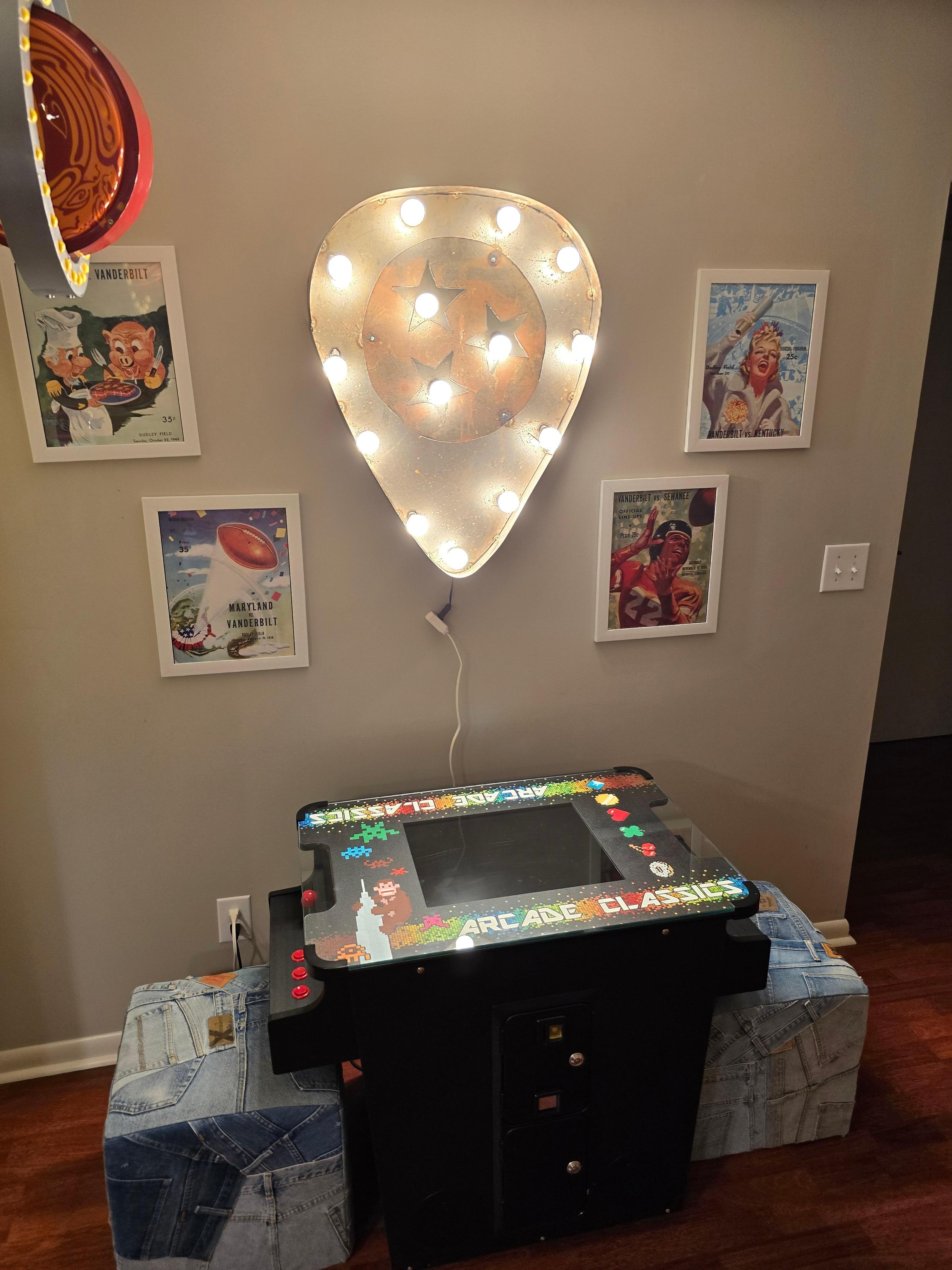 Guitar pick light over multicade game.