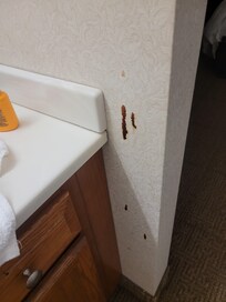 Stains on vanity wall and floor