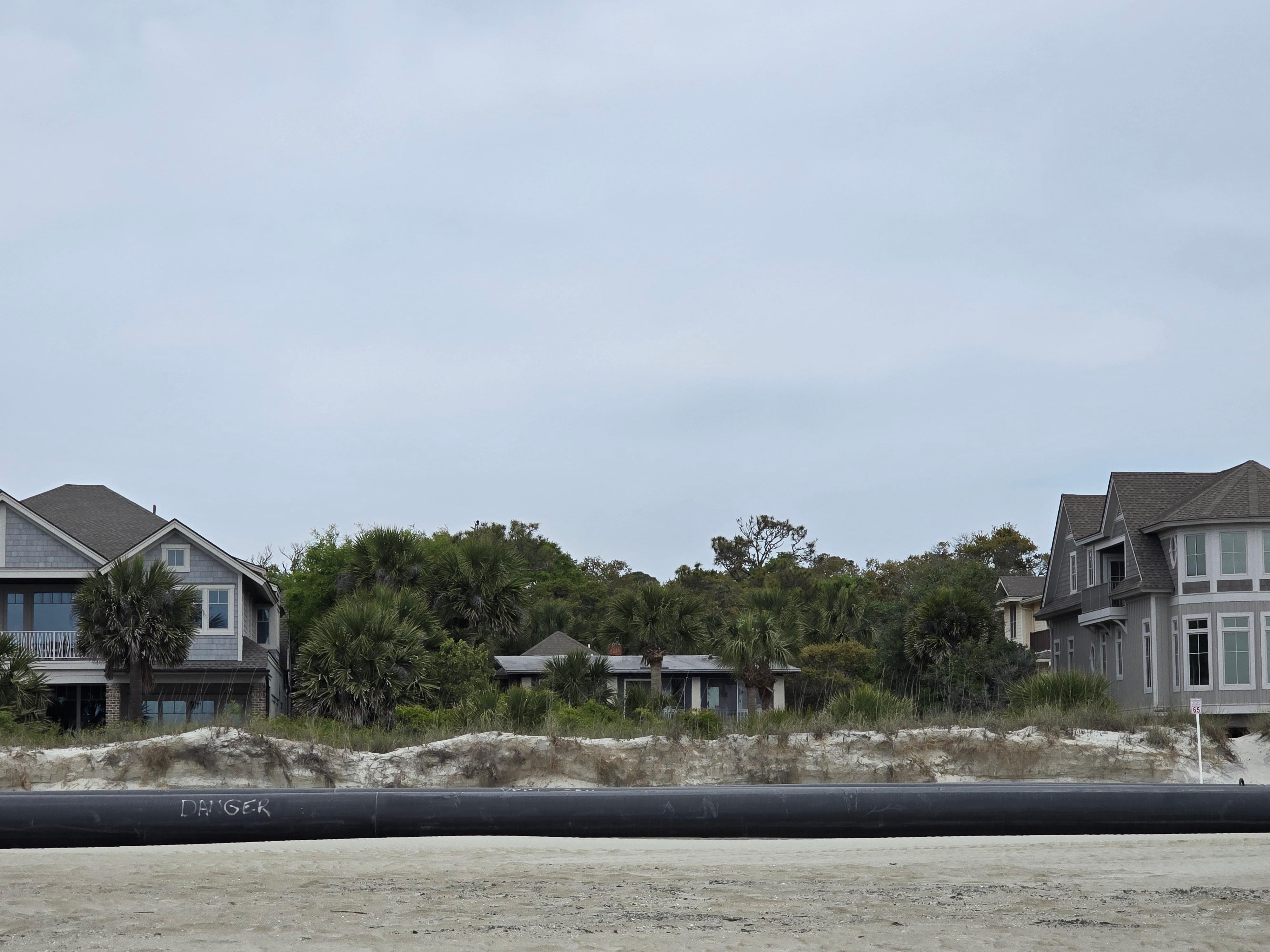 Beach frontage with pipes.