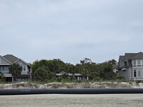 Beach frontage with pipes.