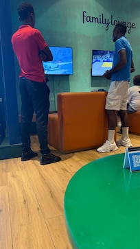 Staff testing the video games while my child waits.