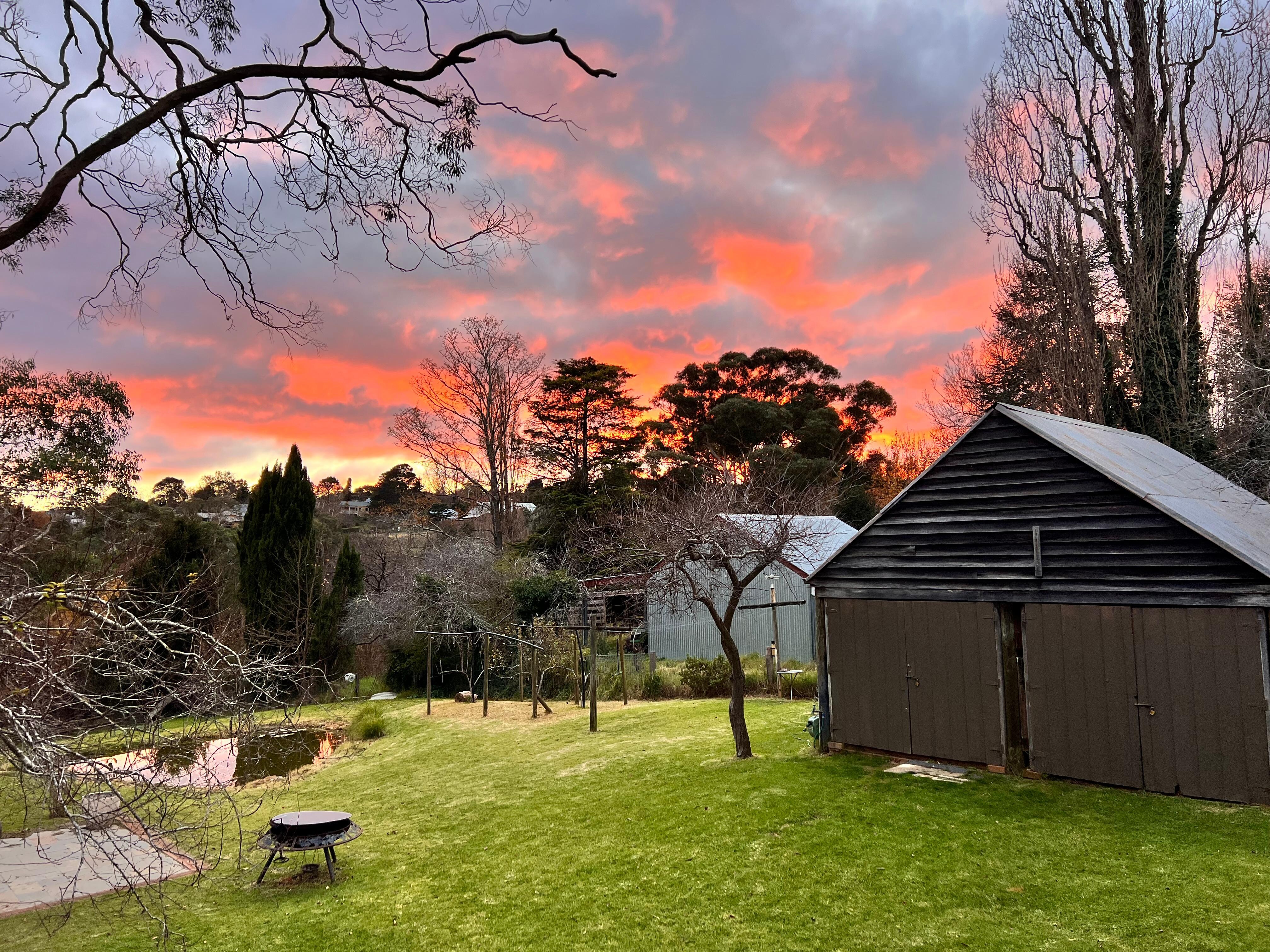 Sunrise view from one of the upstairs bedrooms looking over the (shared) backyard