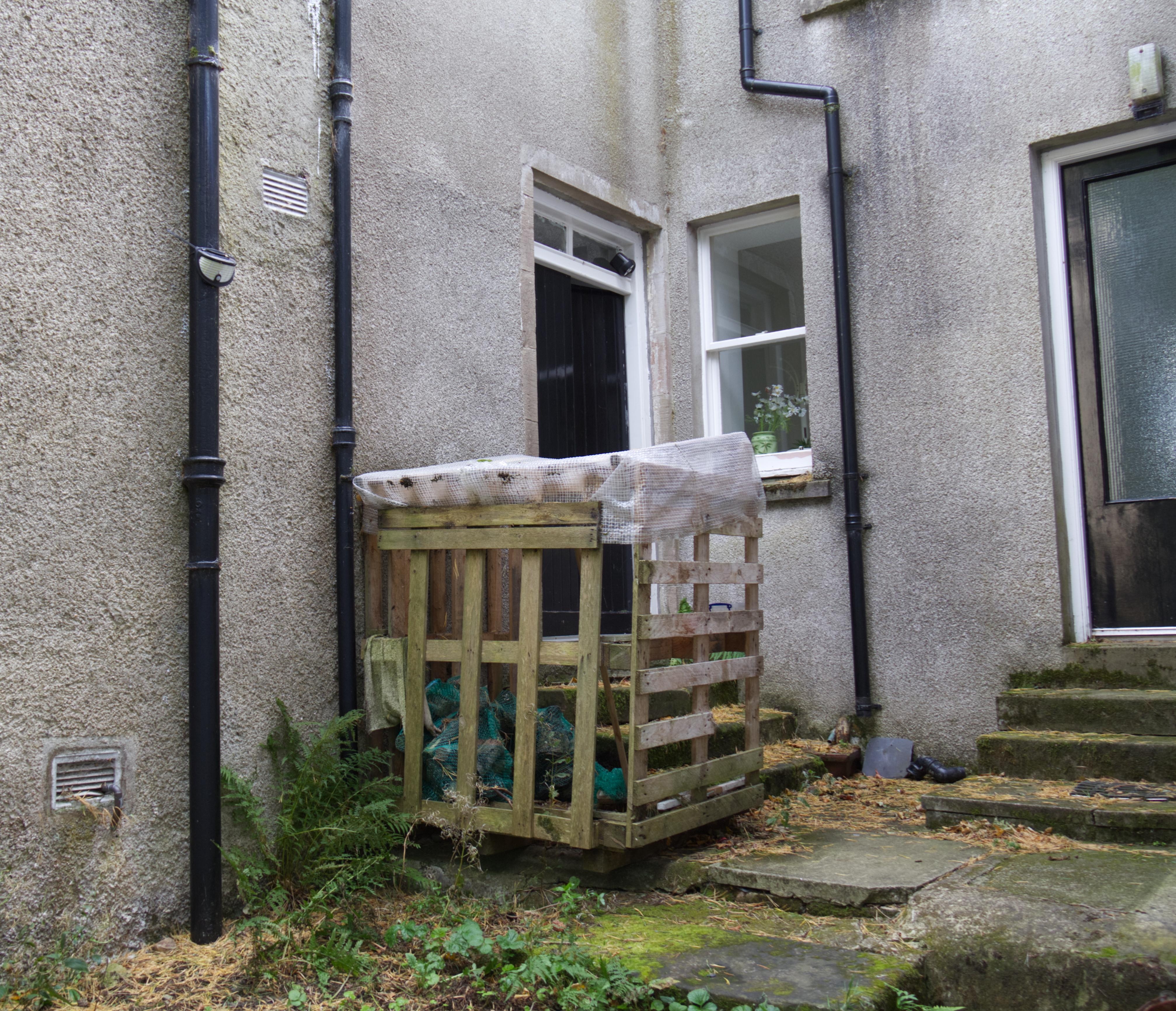 This is the front door to the cottage, on the left next to the crate where firewood is kept.