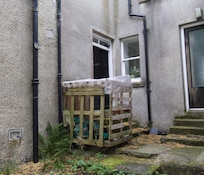 This is the front door to the cottage, on the left next to the crate where firewood is kept.