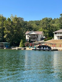 View of back of house from pontoon across lake