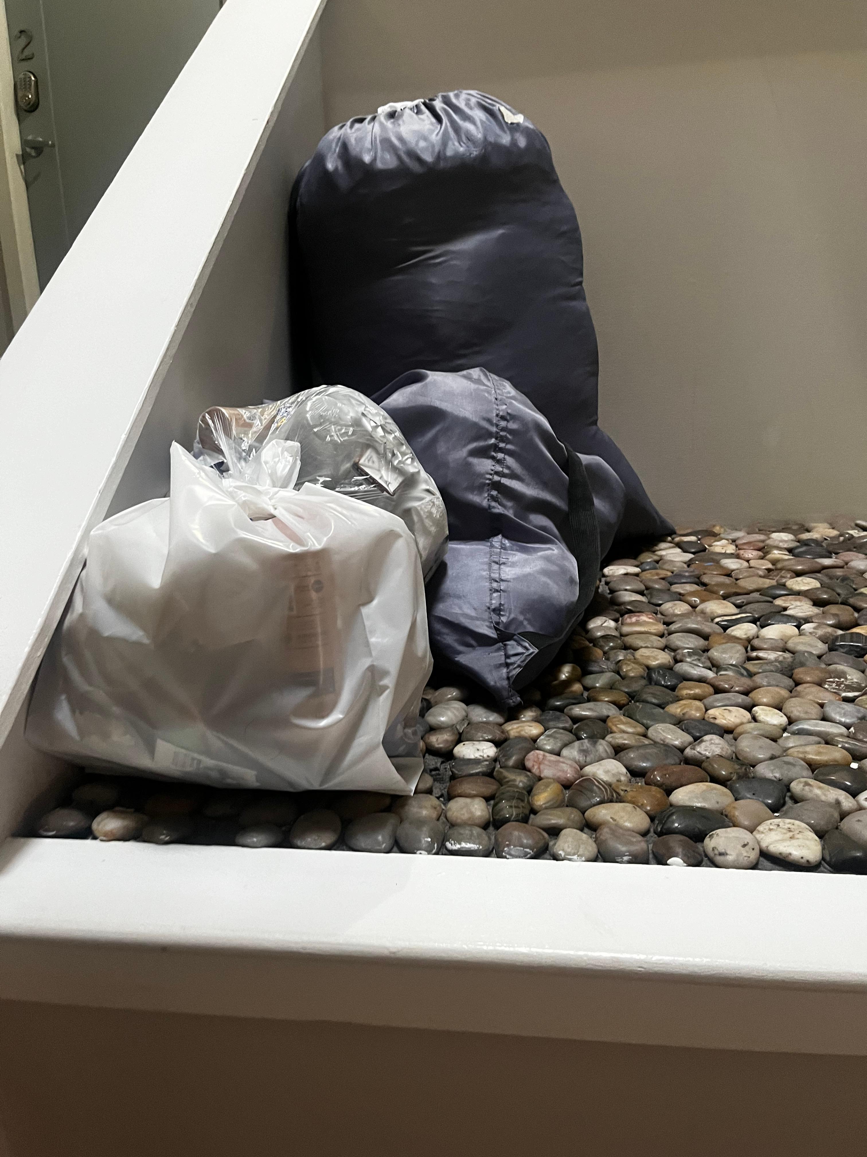 Garbage and laundry piled in the middle of the stairs 