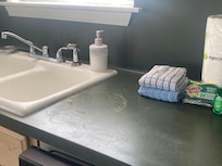 Damaged countertops and broken faucet that sprayed water everywhere.