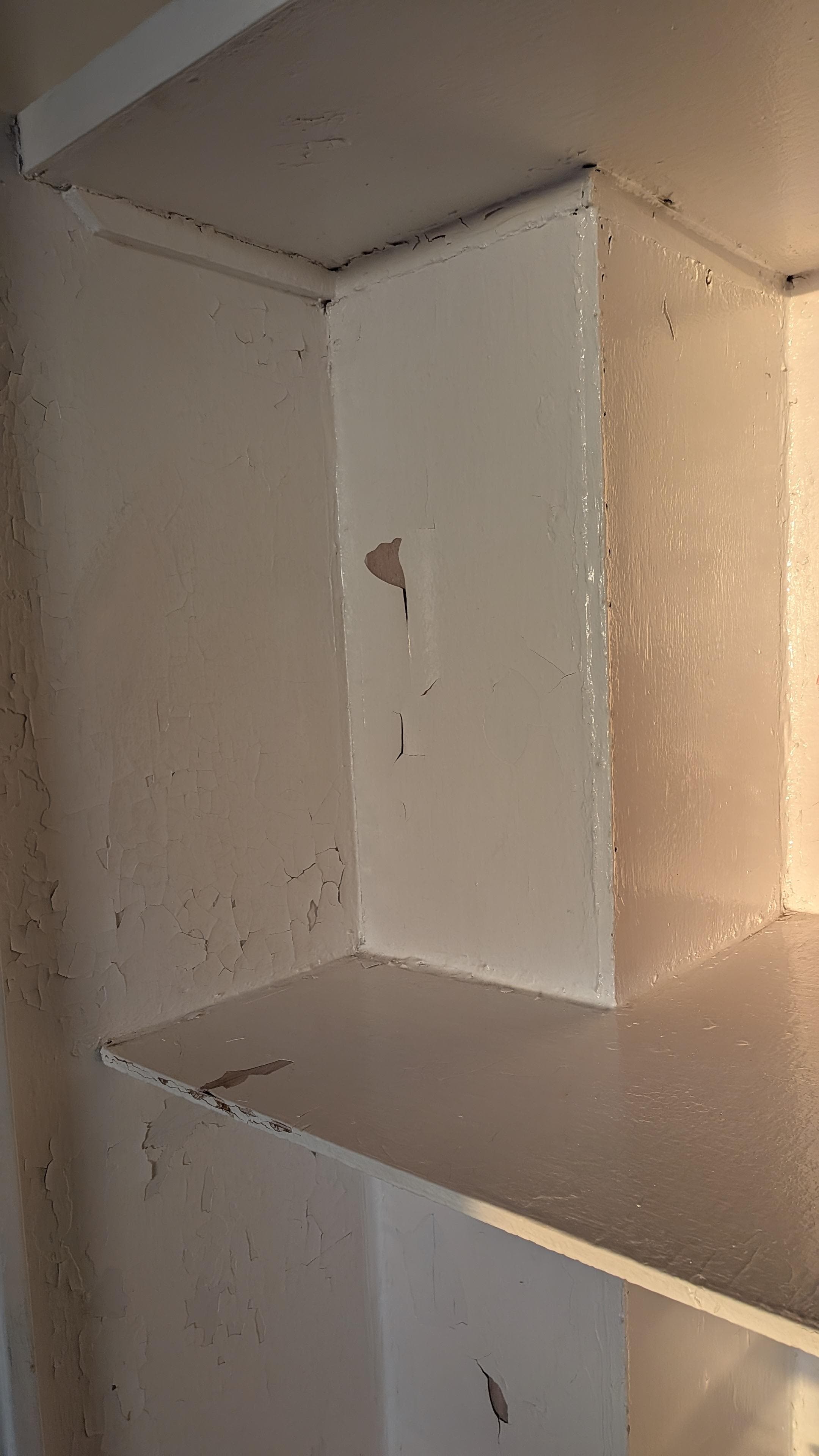 Peeling paint on shelves and walls