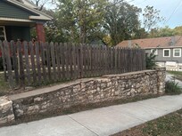 The beautiful rock wall bordering the street