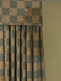 Stained and dirty curtains in the hotel room.