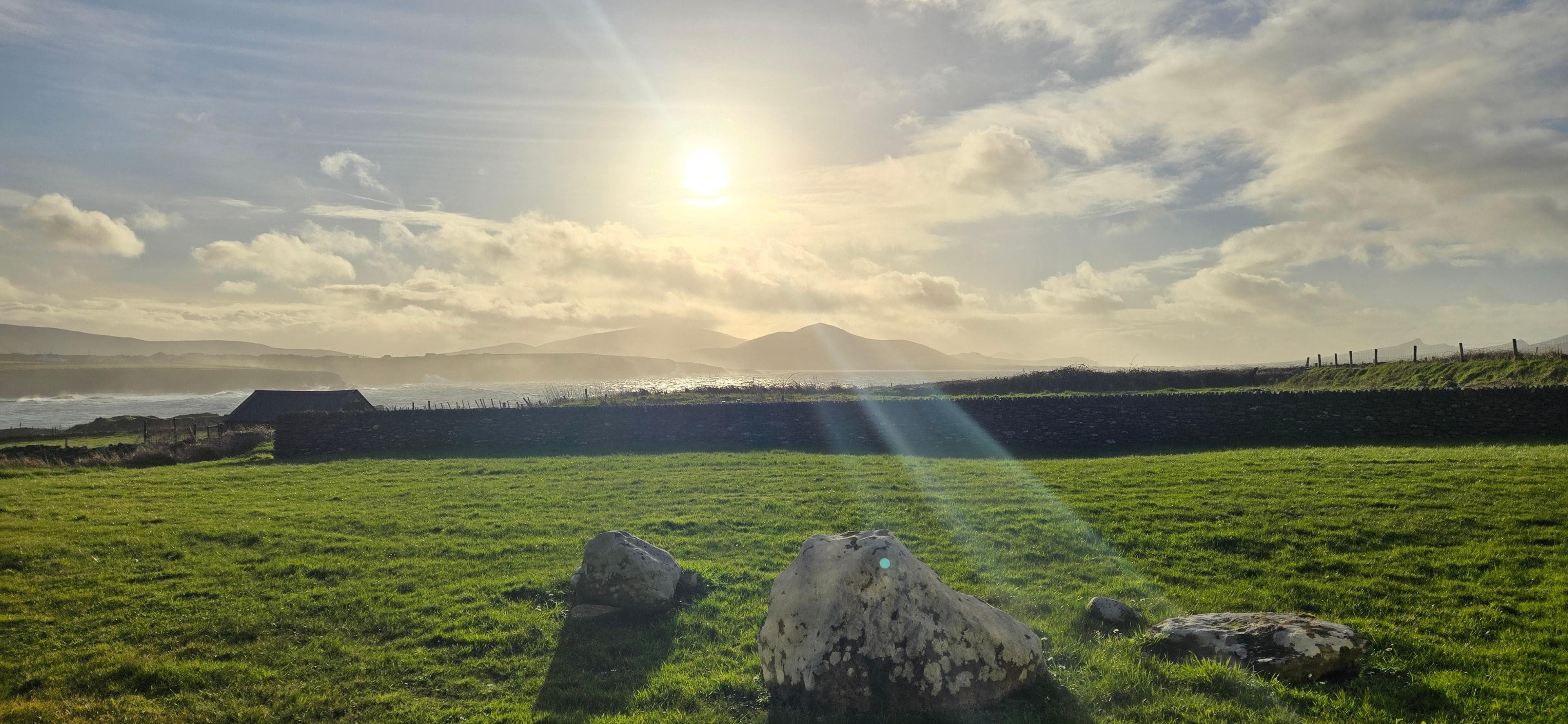 Sitting outside, overlooking the sea and the mountains.