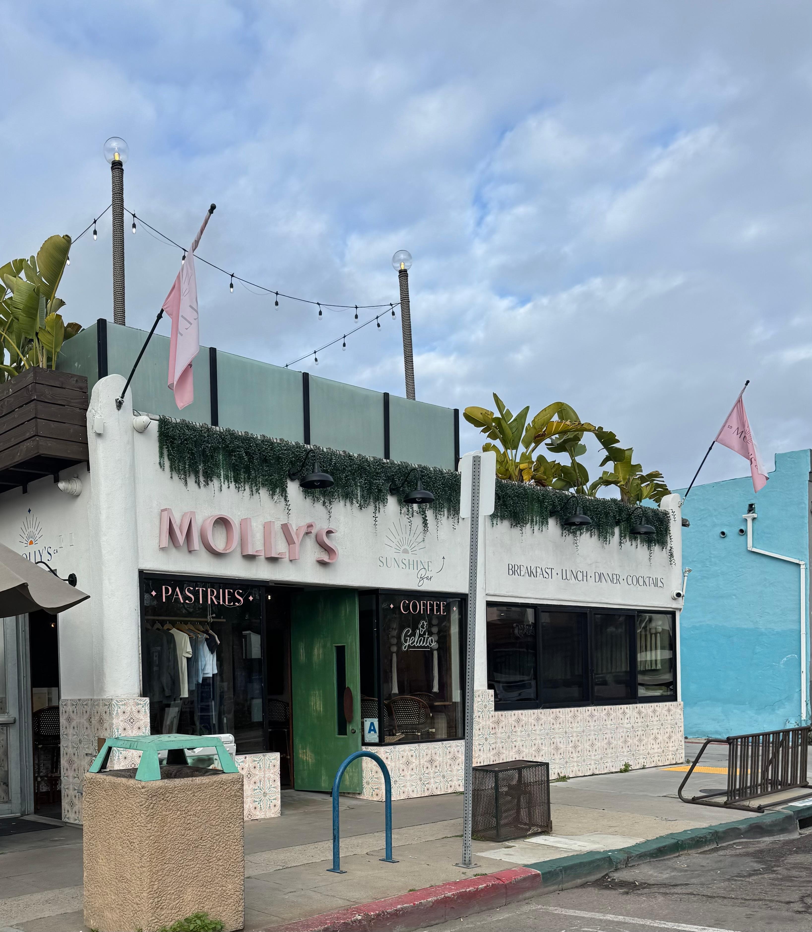 The path to the front door and lockbox is down the path just left of Molly’s (a super cute brunch spot).