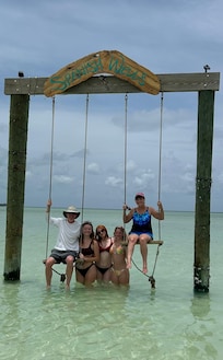 Enjoying the swings at the public beach on the island.
