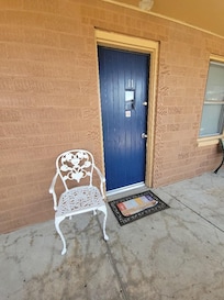 Entrance to the room. Cute door and chair-inviting.