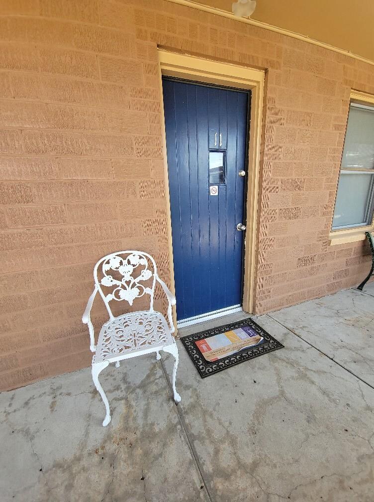 Entrance to the room. Cute door and chair-inviting.